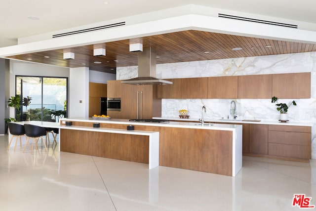 kitchen with island exhaust hood, wood ceiling, stainless steel appliances, and backsplash