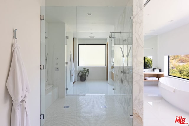 bathroom featuring independent shower and bath and tile patterned flooring