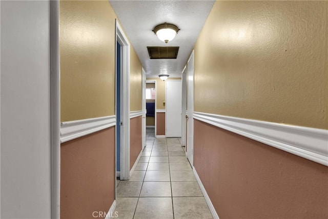 corridor with light tile patterned floors