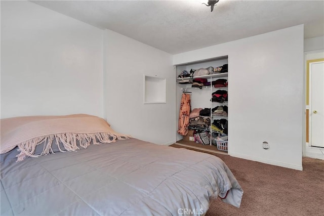 bedroom with carpet and a closet