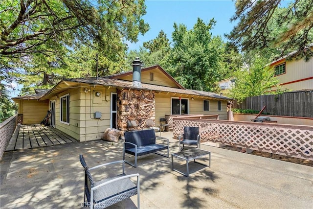 rear view of house featuring an outdoor living space and a deck