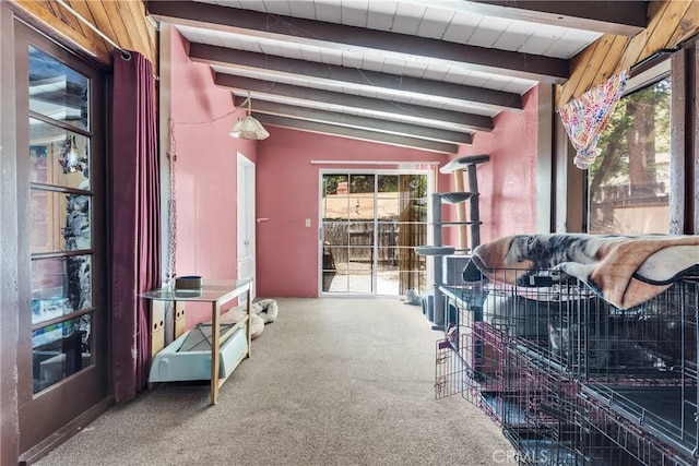 living room with carpet flooring and vaulted ceiling with beams