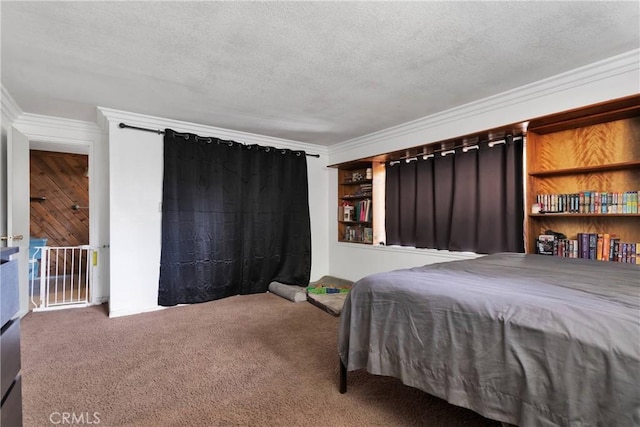 bedroom featuring crown molding, carpet floors, and a textured ceiling