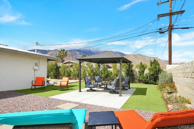 view of patio / terrace with an outdoor living space, a mountain view, and a gazebo