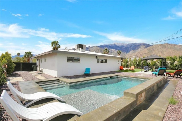 view of swimming pool with a mountain view, a patio area, and a gazebo