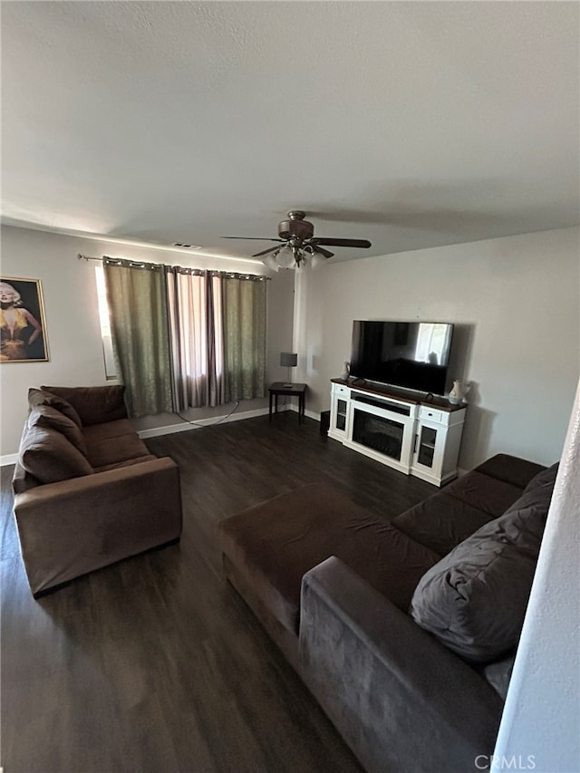 living room featuring ceiling fan and hardwood / wood-style floors