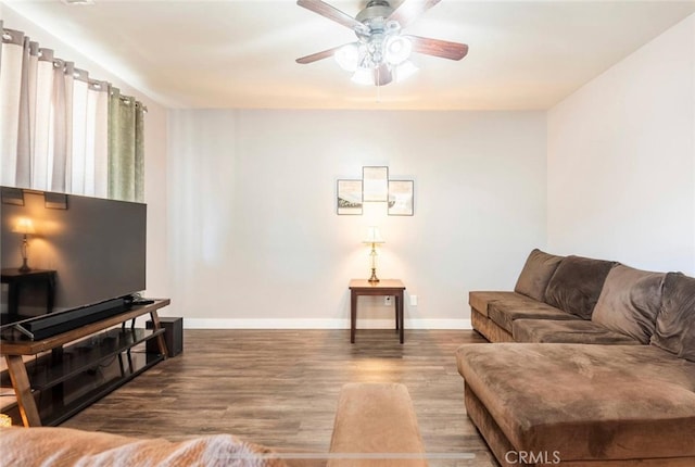 living room featuring ceiling fan and hardwood / wood-style flooring