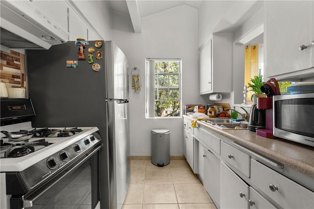 kitchen with light tile patterned floors, white cabinetry, range hood, white gas range, and sink