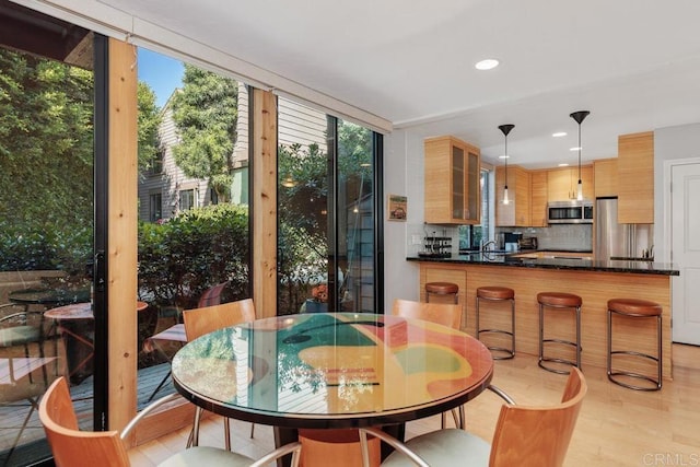 dining area featuring light hardwood / wood-style flooring and sink