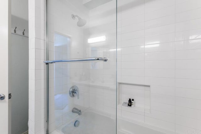 bathroom with shower / bath combination with glass door