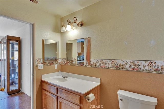 bathroom featuring hardwood / wood-style floors, vanity, and toilet