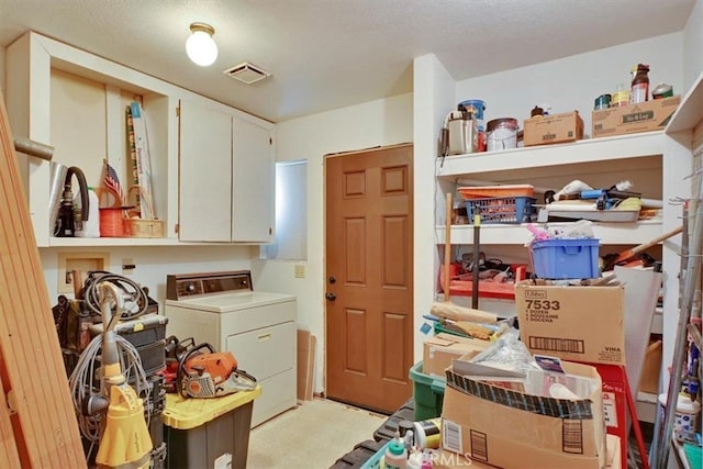 interior space featuring washer / clothes dryer, cabinets, and a textured ceiling