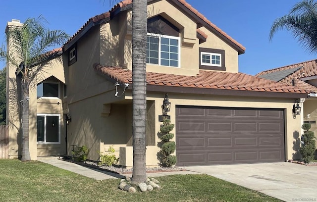 view of front of property featuring a front lawn and a garage