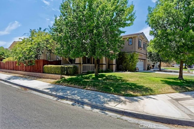 view of front of house with a garage and a front yard