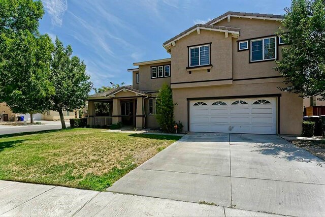 view of property with a garage and a front yard