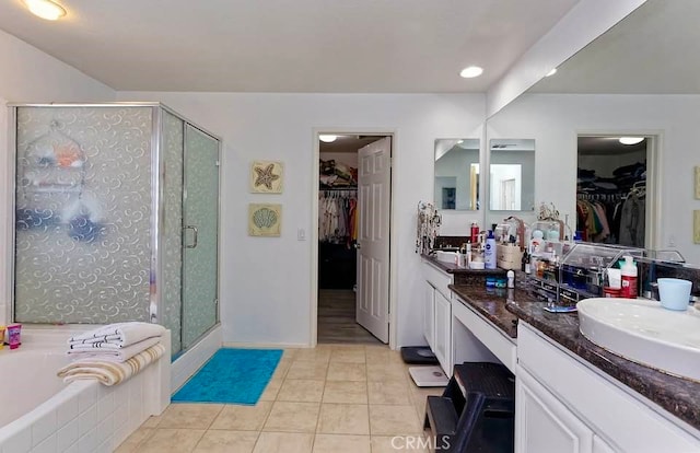 bathroom with tile patterned floors, shower with separate bathtub, and vanity