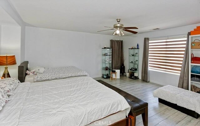 bedroom featuring wood-type flooring and ceiling fan