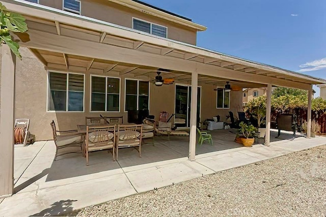 back of property with ceiling fan and a patio