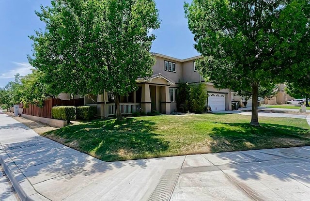 view of property hidden behind natural elements with a garage and a front lawn