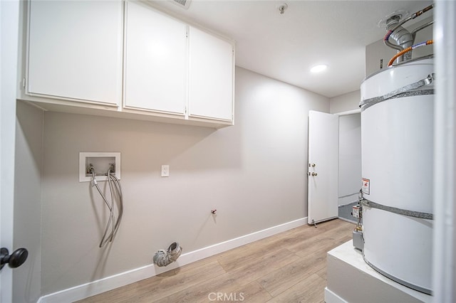 laundry area featuring water heater, light hardwood / wood-style flooring, hookup for a washing machine, and cabinets