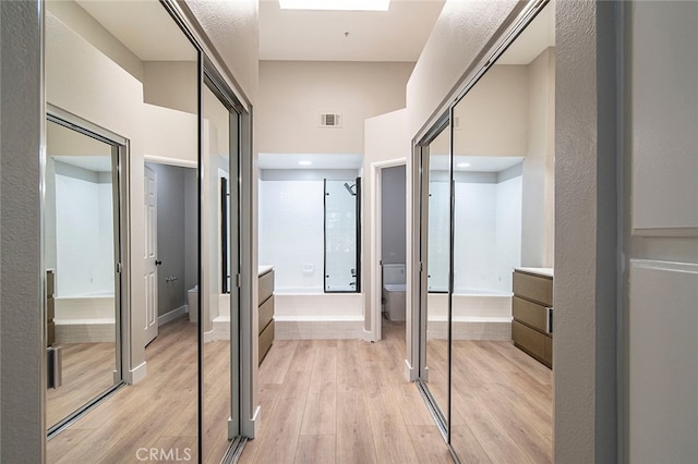 corridor featuring light hardwood / wood-style floors