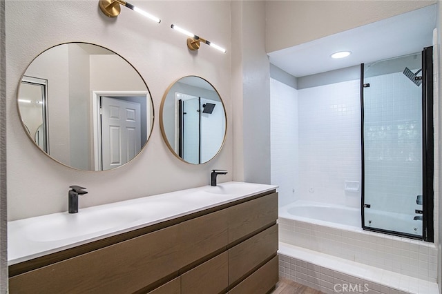 bathroom featuring vanity and tiled shower / bath combo