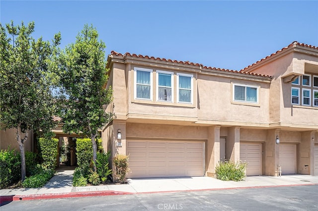 multi unit property featuring a garage