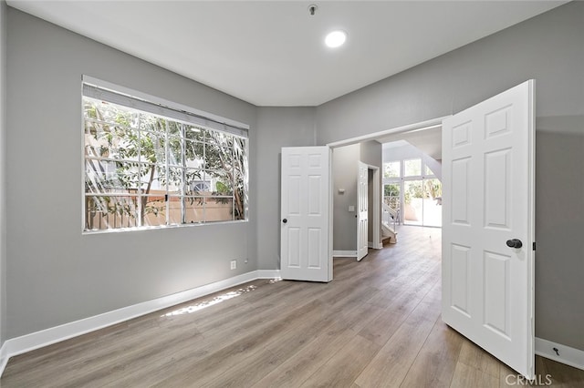 unfurnished room with light hardwood / wood-style flooring