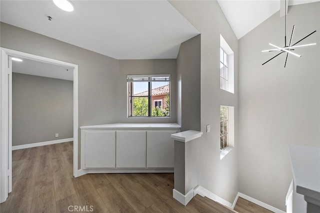 interior space with hardwood / wood-style floors and high vaulted ceiling