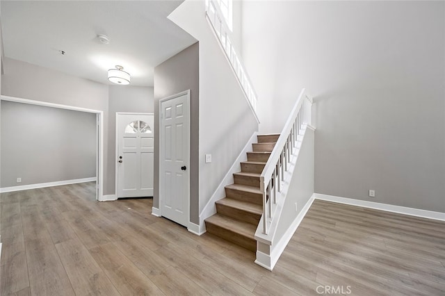 staircase with hardwood / wood-style floors