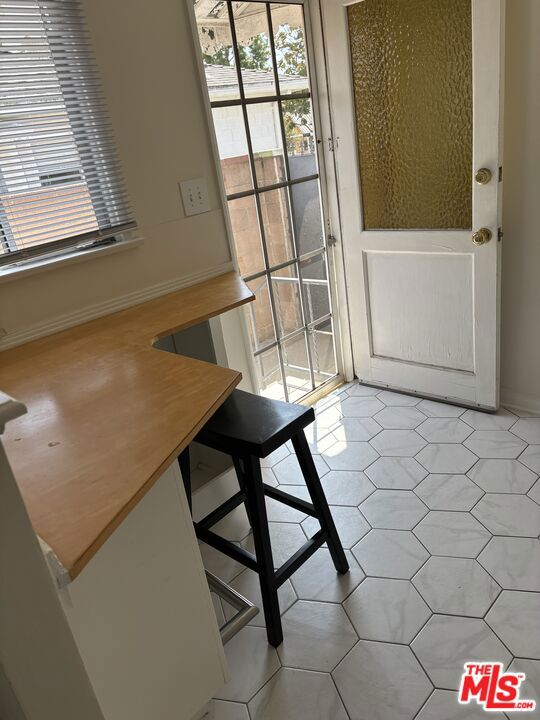 unfurnished dining area featuring light tile patterned floors and a wealth of natural light