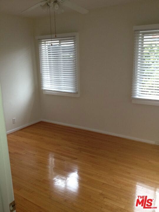 spare room featuring ceiling fan and light wood-type flooring