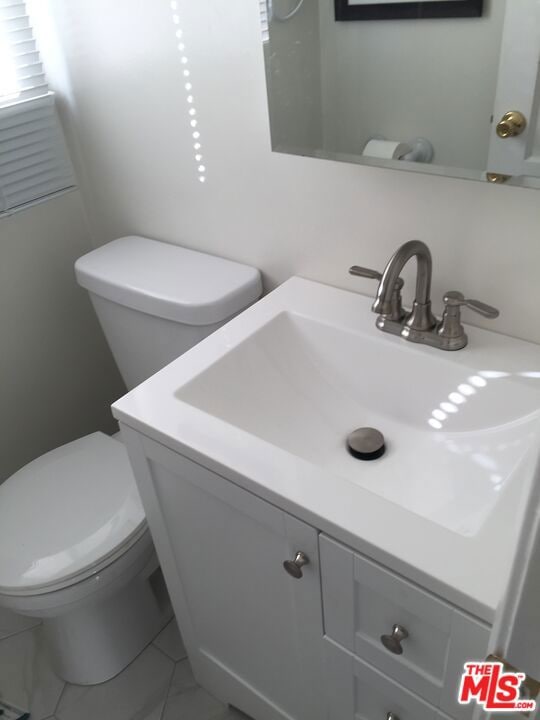 bathroom featuring vanity and toilet