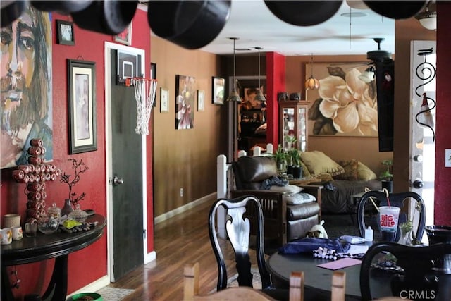 dining space with ceiling fan and dark hardwood / wood-style floors