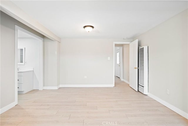 unfurnished room with light wood-type flooring