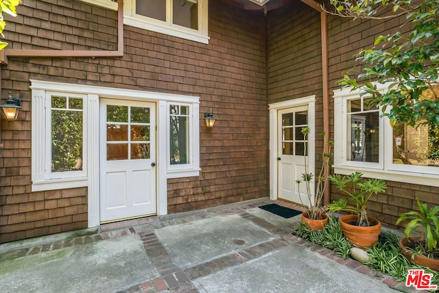 entrance to property featuring a patio