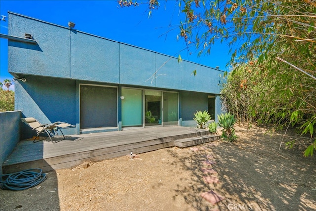 back of house featuring a wooden deck