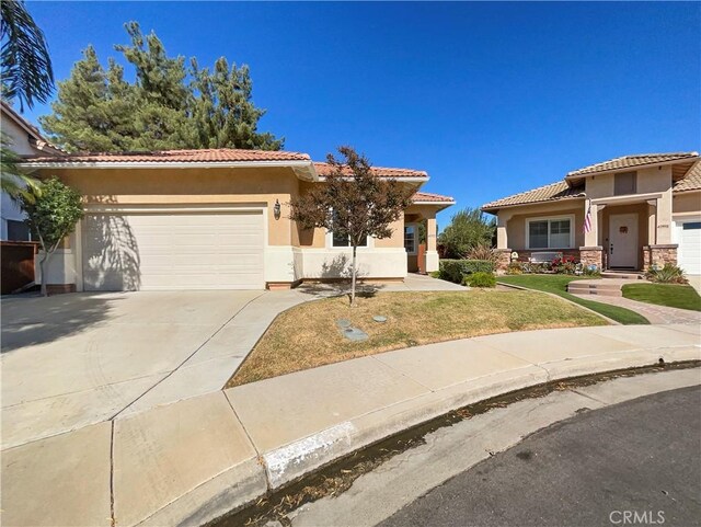 mediterranean / spanish-style home with a garage