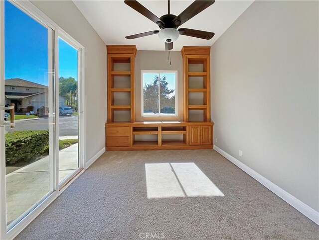 interior space with light colored carpet and ceiling fan