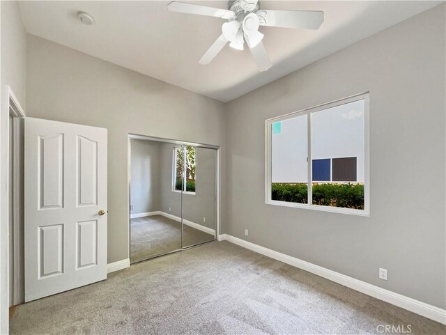 unfurnished bedroom with carpet flooring, a closet, and ceiling fan