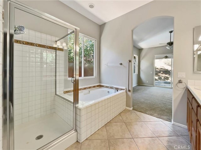 bathroom with tile patterned floors, ceiling fan, vanity, and independent shower and bath