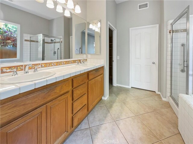 bathroom with tile patterned flooring, vanity, an enclosed shower, and radiator heating unit