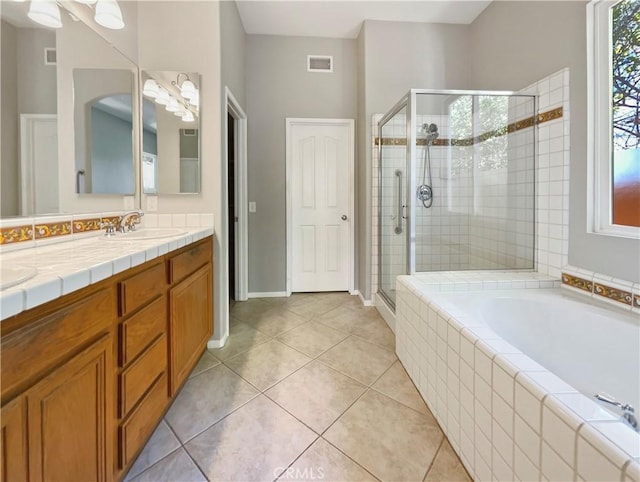 bathroom featuring tile patterned floors, vanity, and shower with separate bathtub