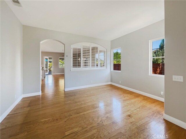 spare room with light hardwood / wood-style flooring