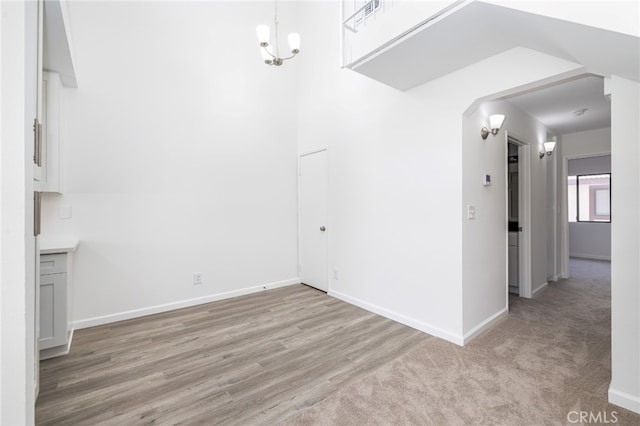 interior space with a chandelier and light hardwood / wood-style floors