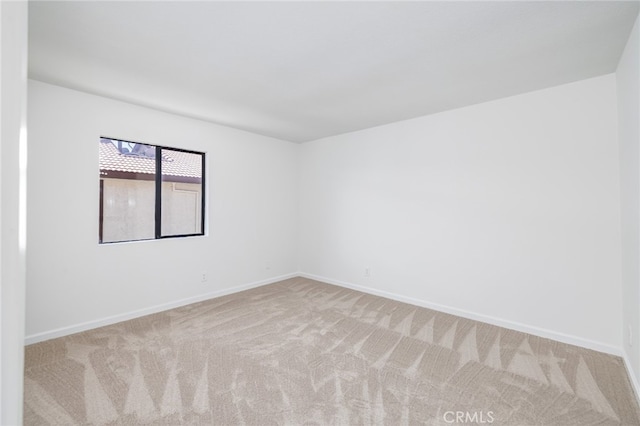 unfurnished room with light carpet