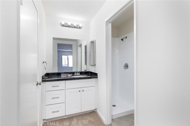 bathroom featuring a shower and vanity