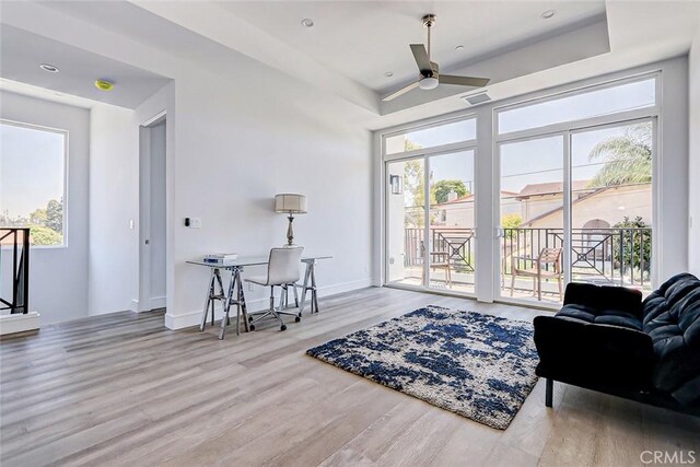 interior space with light hardwood / wood-style floors, ceiling fan, and a healthy amount of sunlight