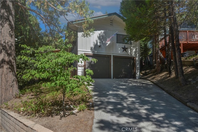 view of property exterior with a deck and a garage