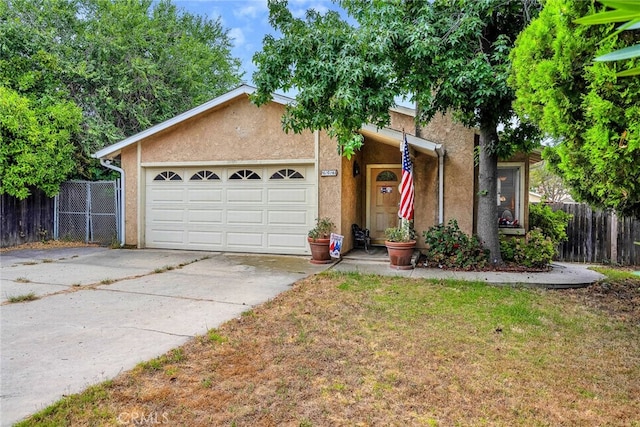 ranch-style house featuring a front yard and a garage